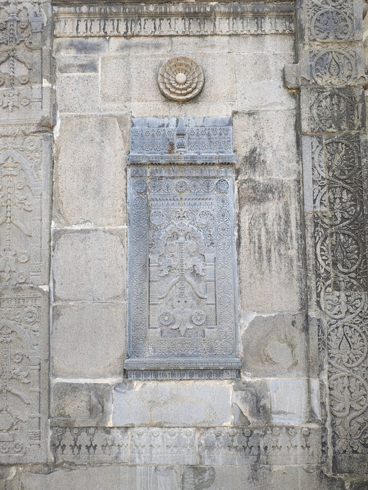 Intricately carved stone panel with a floral rosette at Chhoto Sona Masjid, Chapainawabganj